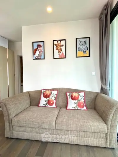 Stylish living room with cozy sofa and artistic wall decor in modern apartment.