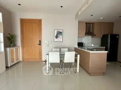 Modern open-layout kitchen and dining area with sleek cabinetry and stylish decor.