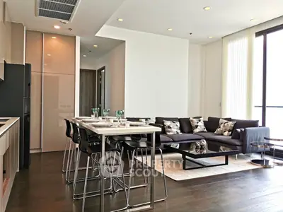 Modern open-plan living room with sleek kitchen and stylish decor