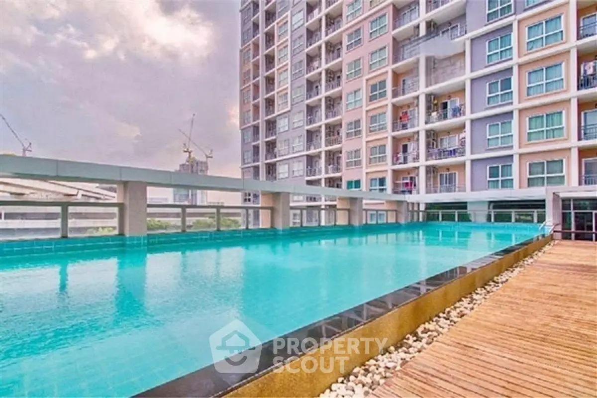 Luxurious apartment building with stunning rooftop pool and modern design.