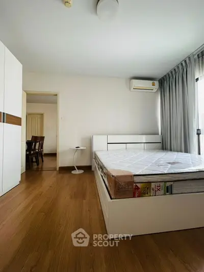 Spacious bedroom with modern furnishings and natural light