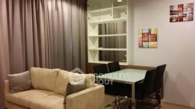Modern living room with cozy beige sofa and stylish dining area