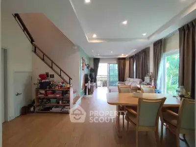 Spacious living room with dining area and modern decor in a bright, open-concept home.