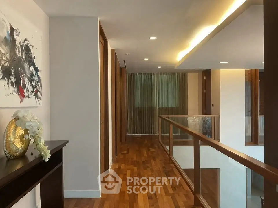 Elegant hallway with wooden flooring and modern decor in luxury home