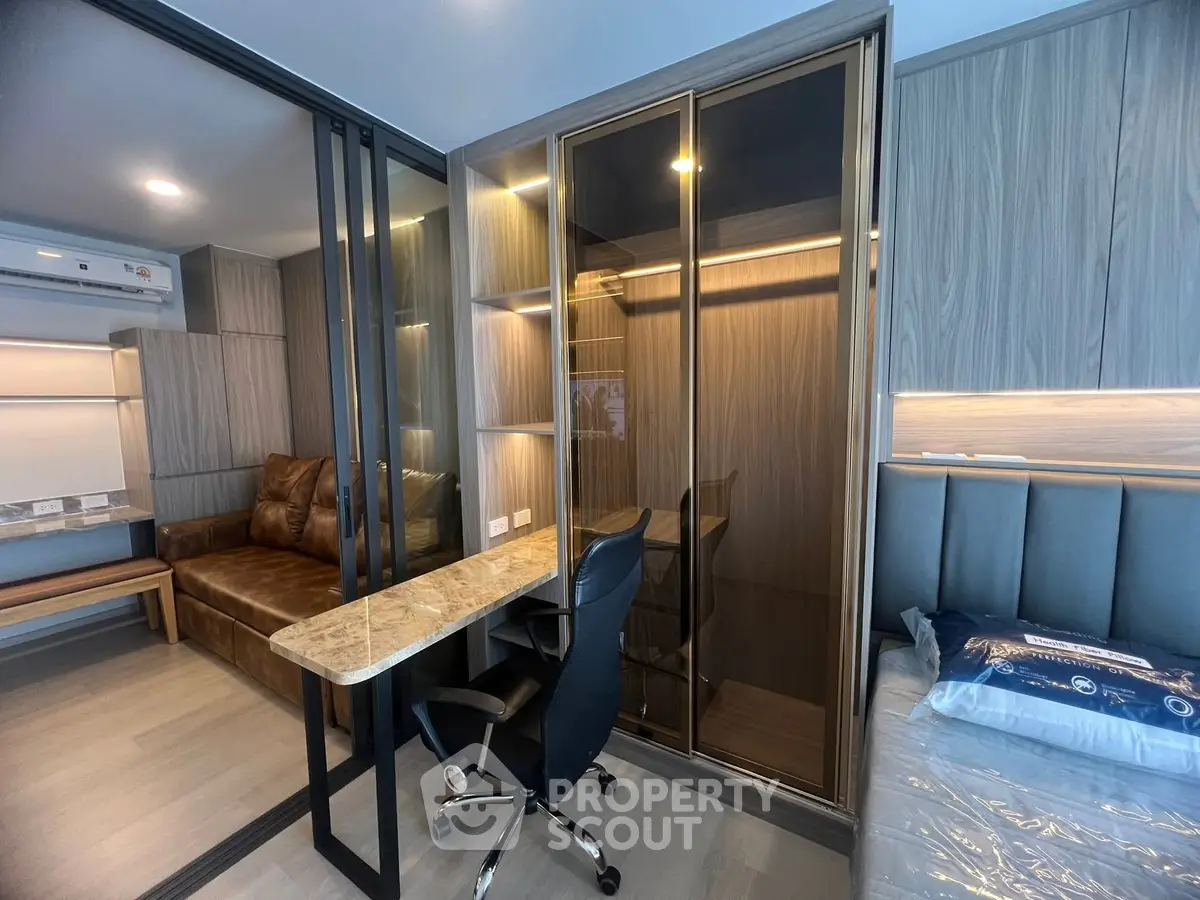 Modern studio apartment with sleek design, featuring a cozy living area and stylish workspace.