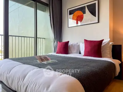 Modern bedroom with stylish decor and balcony access in a high-rise apartment.