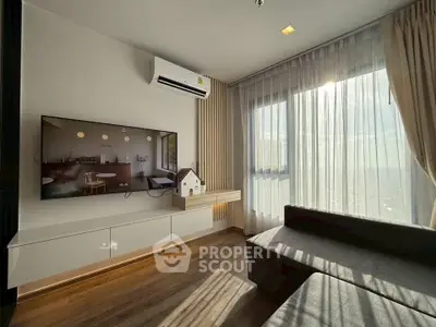 Modern living room with large window, wall-mounted TV, and stylish decor.