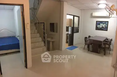 Spacious interior with dining area, bedroom, and staircase in modern home