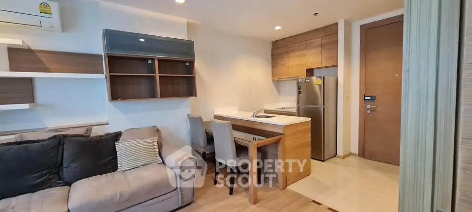 Modern apartment interior with cozy living room and compact kitchen area.