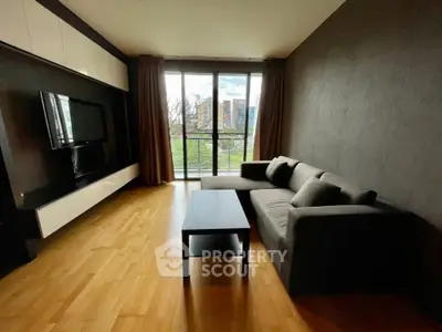 Modern living room with sleek furniture and large window view
