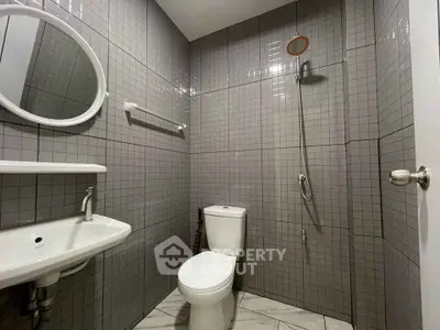 Modern bathroom with sleek gray tiles and minimalist fixtures