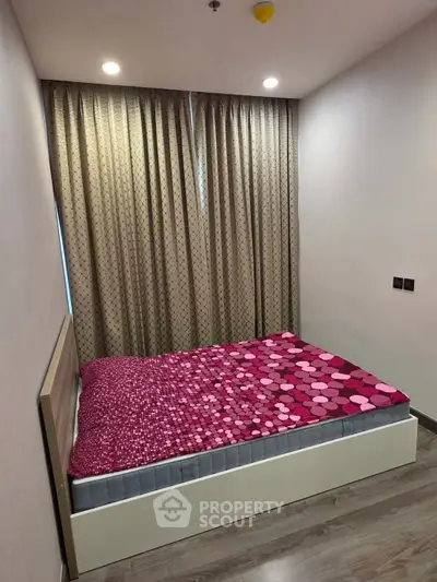 Cozy bedroom with modern decor and stylish curtains, perfect for relaxation and comfort.