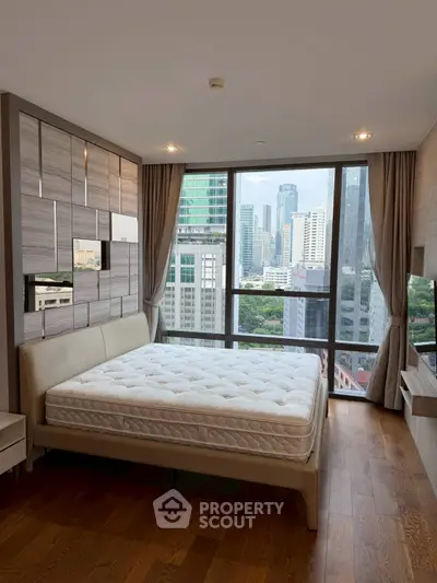 Luxurious bedroom with stunning city view from floor-to-ceiling windows in modern high-rise apartment.