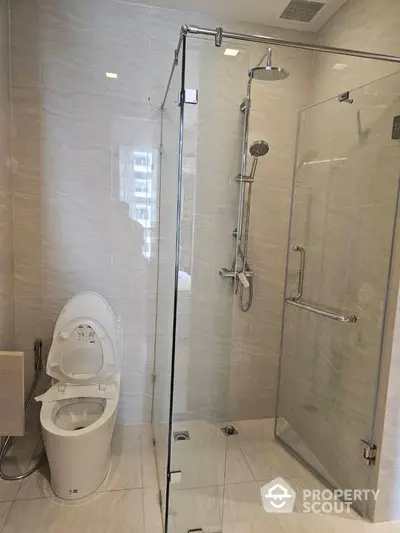 Modern bathroom with glass shower enclosure and sleek toilet design