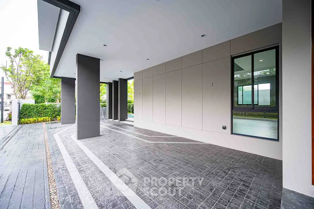 Modern house entrance with sleek design and spacious driveway