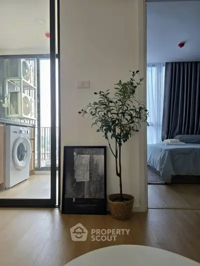 Modern apartment interior with washing machine and cozy bedroom view