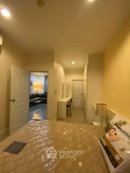 Cozy bedroom with modern decor and soft lighting, featuring a comfortable bed and stylish furniture.