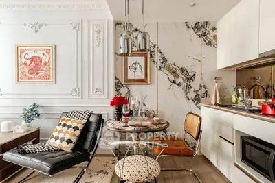 Stylish modern kitchen with marble accents and chic dining area