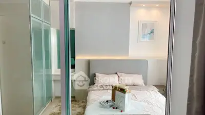 Modern bedroom with stylish decor and soft lighting, featuring a cozy bed and elegant furnishings.