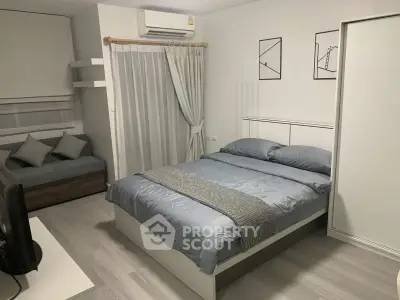 Modern bedroom with sleek design, featuring a cozy bed, stylish decor, and ample natural light.