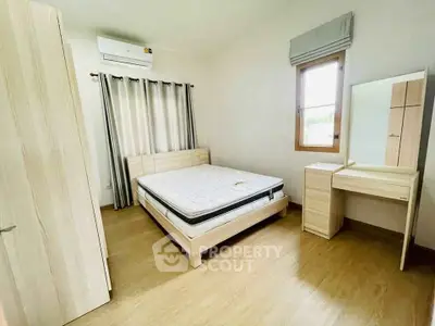 Bright and airy bedroom with modern furnishings and natural light.