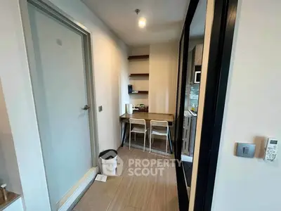 Cozy study nook with modern decor and ample shelving in a compact apartment.