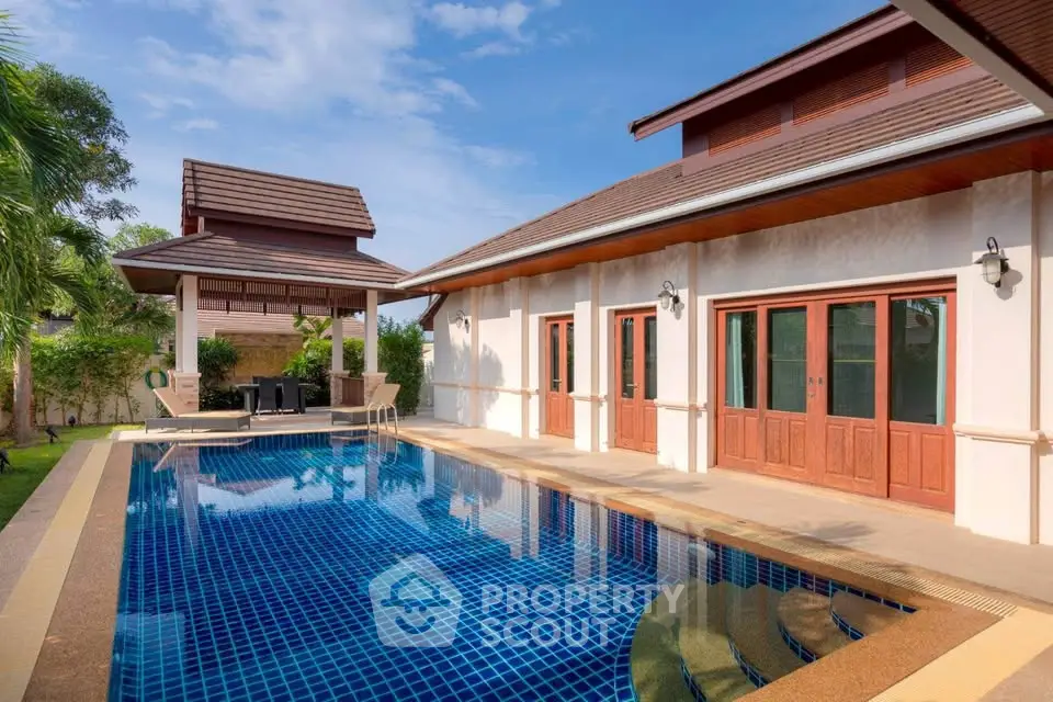 Luxurious villa with private pool and elegant architecture under clear blue sky.
