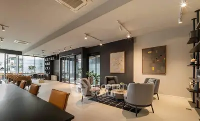 Modern living room with stylish furniture and open layout, featuring elegant lighting and contemporary decor.