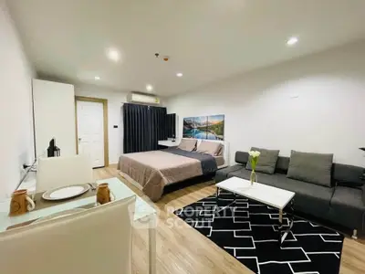 Modern studio apartment with cozy living area and stylish decor