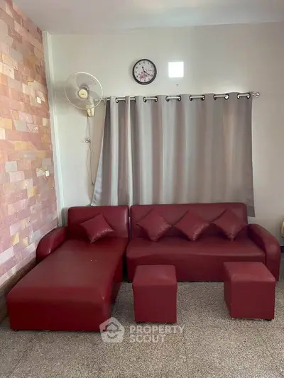 Stylish living room with red sofa set and modern decor, perfect for cozy gatherings.