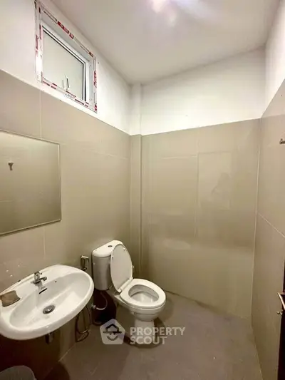 Modern bathroom with sleek fixtures and neutral tiles, perfect for a minimalist home.