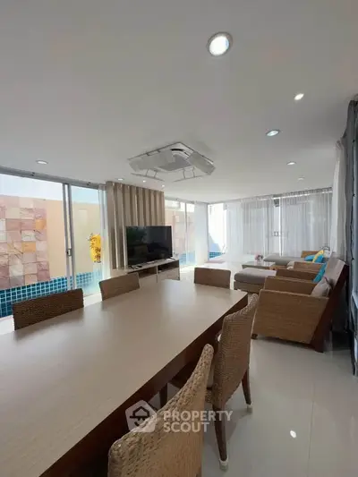 Spacious living room with pool view and modern decor