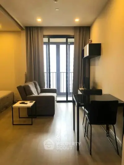 Modern living room with sleek furniture and balcony access in a stylish apartment.