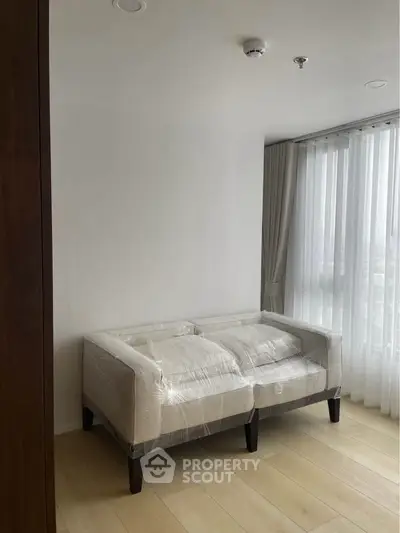 Modern living room with natural light and new furniture in a cozy apartment.