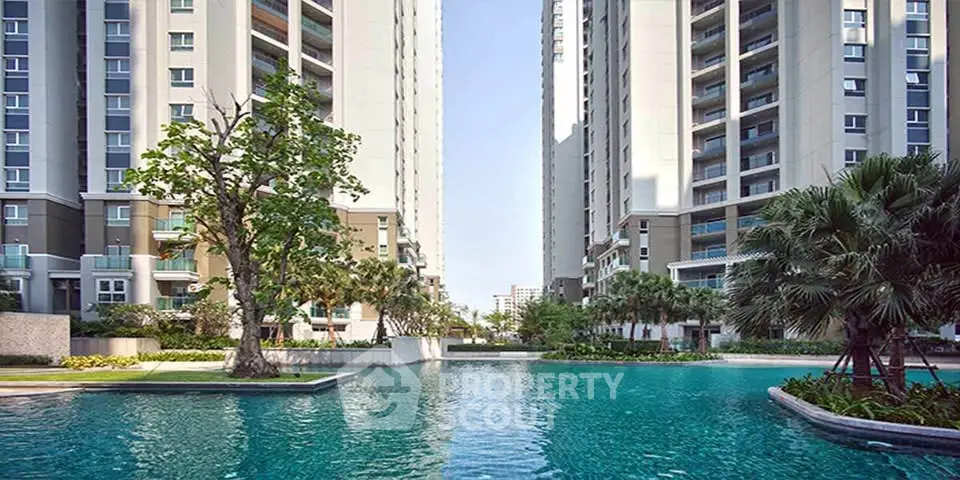 Luxurious residential complex with stunning pool and modern high-rise buildings.