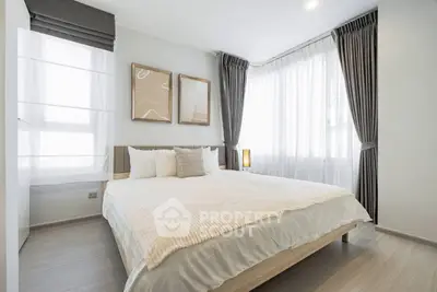 Bright and modern bedroom with large windows and stylish decor.