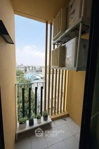 Charming balcony with city view and potted plants, perfect for relaxation.