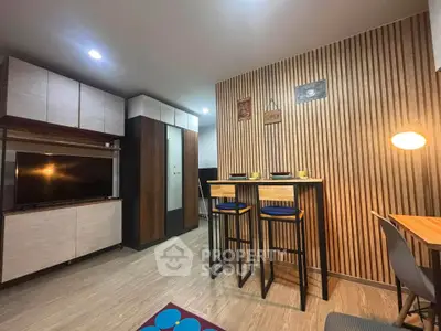 Modern living room with stylish wooden paneling and cozy dining area