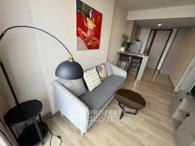 Modern living room with stylish decor and open layout, featuring a cozy sofa and contemporary artwork.