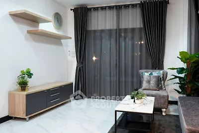 Modern living room with elegant decor, featuring a stylish armchair, sleek shelves, and lush indoor plants.
