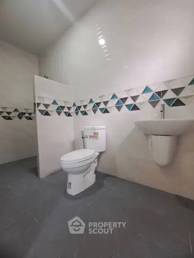 Modern bathroom with geometric tile accents and sleek fixtures