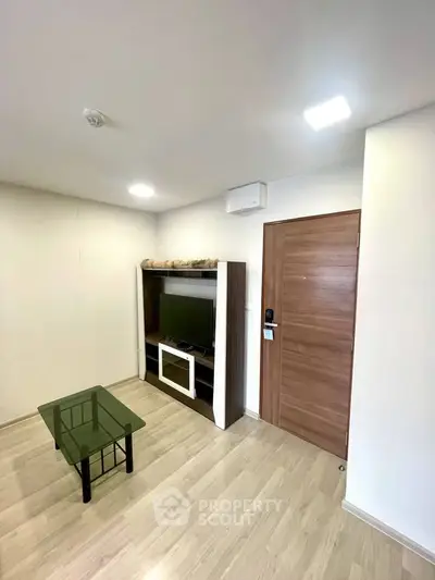 Modern living room with wooden flooring and sleek furniture design