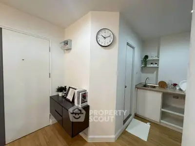 Modern apartment entrance with compact kitchen and stylish decor