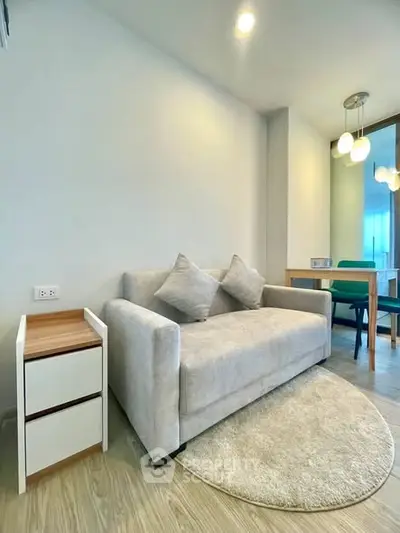 Modern living room with cozy sofa and stylish dining area in a bright apartment.