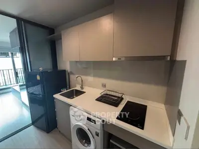 Modern kitchen with sleek cabinetry and built-in appliances in a stylish apartment.