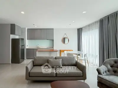 Modern open-plan living room with sleek kitchen and stylish furniture