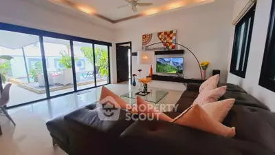 Spacious living room with modern decor and large sliding doors to a bright balcony.