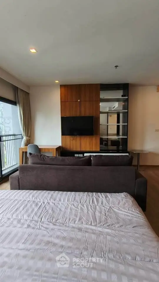 Modern bedroom with stylish decor and city view balcony