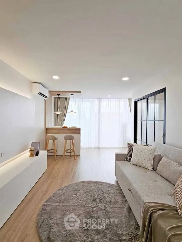 Modern living room with cozy sofa and stylish open kitchen layout
