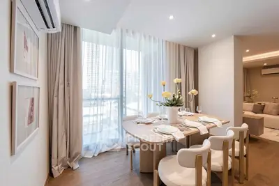 Elegant dining area with modern decor and large windows in a stylish apartment.